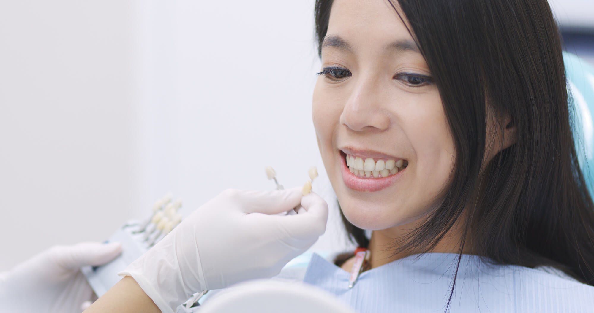 Patient choosing a shade for her dental crowns in Kennett Square